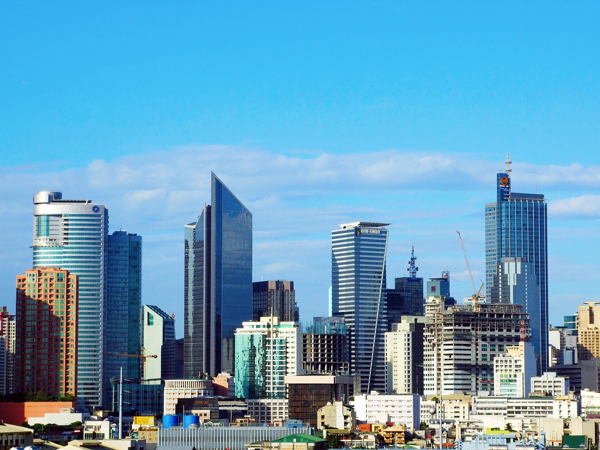 The towers of the Makati central business district under a clear sky