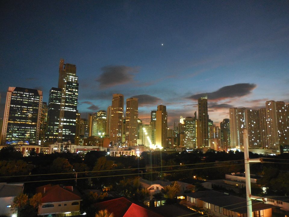 The business district at dusk over village rooftops
