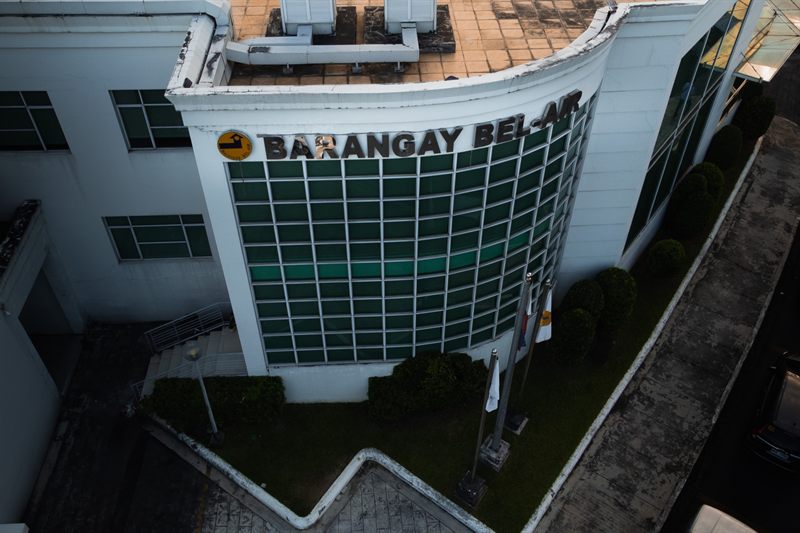 The Barangay Bel-Air hall from above, its name across the curved front