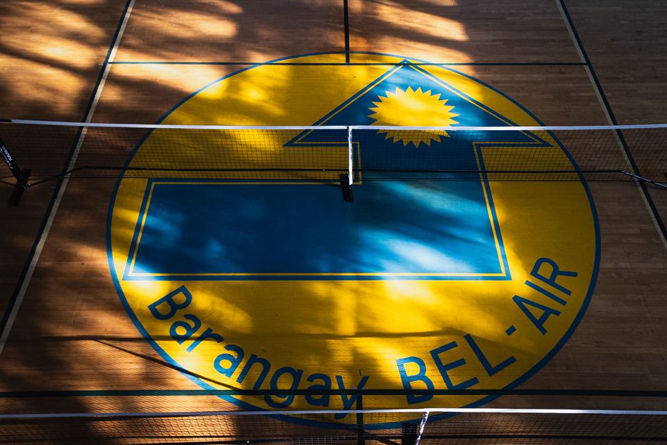 The barangay seal painted on a basketball court, seen from above