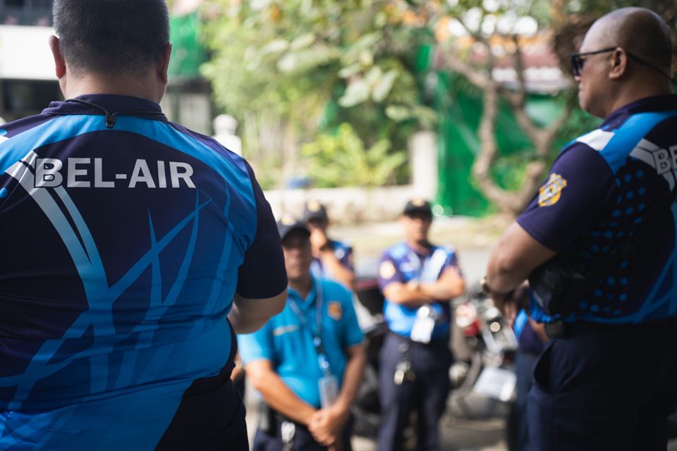 Barangay tanods in Bel-Air jerseys at a briefing